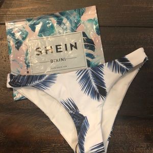 SHEIN white with blue leaves swim bottoms.